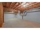 Unfinished basement space with exposed ceiling, ductwork, and painted concrete walls at 5344 Mill Dam Rd, Wake Forest, NC 27587