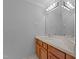 Bright bathroom featuring a wood vanity, sink, large mirror, and ample lighting at 5344 Mill Dam Rd, Wake Forest, NC 27587