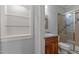 Bathroom features a wooden vanity, glass shower, and a storage shelf at 5344 Mill Dam Rd, Wake Forest, NC 27587