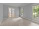 Spacious bedroom with neutral carpet, crown molding, and double glass doors at 5344 Mill Dam Rd, Wake Forest, NC 27587