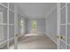Bright bedroom with neutral carpet and natural light, viewed through double doors at 5344 Mill Dam Rd, Wake Forest, NC 27587