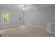 Spacious bedroom featuring neutral walls, carpet, ceiling fan, and two bright windows offering natural light at 5344 Mill Dam Rd, Wake Forest, NC 27587