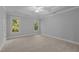 Empty primary bedroom with carpeting, two windows, a ceiling fan, and detailed tray ceiling at 5344 Mill Dam Rd, Wake Forest, NC 27587