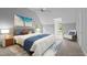 A staged bedroom with a neutral palette, carpet, a ceiling fan, and three windows for plenty of natural light at 5344 Mill Dam Rd, Wake Forest, NC 27587