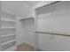 An organized walk-in closet with shelving and rods for hanging garments and a carpeted floor at 5344 Mill Dam Rd, Wake Forest, NC 27587