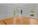 Spacious dining room with hardwood floors, wainscoting, and natural light from windows at 5344 Mill Dam Rd, Wake Forest, NC 27587