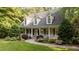 Charming home featuring a welcoming front porch and a beautifully landscaped front yard at 5344 Mill Dam Rd, Wake Forest, NC 27587