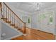 Light-filled foyer with hardwood floors and staircase with decorative wood railing at 5344 Mill Dam Rd, Wake Forest, NC 27587