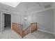 Upstairs hallway with carpeted floor, wooden banister, and modern pendant lighting at 5344 Mill Dam Rd, Wake Forest, NC 27587