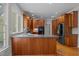 The kitchen has wood cabinets, recessed lighting, and a breakfast bar with wood floors at 5344 Mill Dam Rd, Wake Forest, NC 27587
