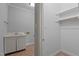 An airy laundry area has a sink and cabinet as well as closet for cleaning supplies and storage at 5344 Mill Dam Rd, Wake Forest, NC 27587