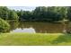 Scenic view of a tranquil pond surrounded by lush greenery, offering a peaceful retreat at 5344 Mill Dam Rd, Wake Forest, NC 27587