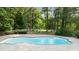 Inviting in-ground swimming pool surrounded by lush landscaping for ultimate privacy at 5344 Mill Dam Rd, Wake Forest, NC 27587