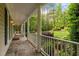 Spacious porch with stone flooring overlooking green lawn and tall trees at 5344 Mill Dam Rd, Wake Forest, NC 27587