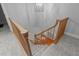 Carpeted staircase featuring wooden railings leading down to a lower level with hardwood floors at 5344 Mill Dam Rd, Wake Forest, NC 27587