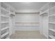 A spacious walk-in closet features built-in shelving and hanging rods for efficient organization at 5344 Mill Dam Rd, Wake Forest, NC 27587