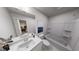 Bright bathroom featuring double sinks, a large mirror, and a tub with a shower at 537 Folk Song Way, Wendell, NC 27591
