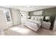 Serene bedroom featuring white bedding, natural light from large windows, and neutral-toned decor at 537 Folk Song Way, Wendell, NC 27591