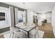 Open-concept dining room with modern chandelier, dining table, and connected kitchen area at 537 Folk Song Way, Wendell, NC 27591