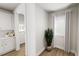 Hallway featuring an interior door and window with white trim and neutral-toned walls and hardwood floors at 537 Folk Song Way, Wendell, NC 27591