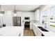 Contemporary kitchen featuring stainless steel appliances, white cabinets and island with hardwood floors at 537 Folk Song Way, Wendell, NC 27591