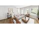 Inviting living room featuring neutral-toned furniture, large windows, hardwood floors, and modern decor at 537 Folk Song Way, Wendell, NC 27591