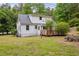 View of the back of house featuring a wooden deck, patio and lots of yard at 5601 Buffaloe Rd, Raleigh, NC 27616