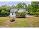 Home's back exterior with a wooden deck perfect for enjoying the outdoors at 5601 Buffaloe Rd, Raleigh, NC 27616