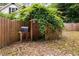 Wooden fence with a vine-covered gate and mailbox, enhancing the property's charm at 5601 Buffaloe Rd, Raleigh, NC 27616