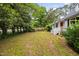 Lush backyard featuring ample space and views of the home's exterior at 5601 Buffaloe Rd, Raleigh, NC 27616
