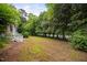 Spacious backyard with lush trees providing ample shade and privacy at 5601 Buffaloe Rd, Raleigh, NC 27616