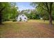Large backyard featuring home and a storage building at 5601 Buffaloe Rd, Raleigh, NC 27616