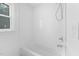 Bright white bathroom featuring a shower and tub at 5601 Buffaloe Rd, Raleigh, NC 27616