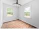 Bedroom with a ceiling fan, two windows, and hardwood floors at 5601 Buffaloe Rd, Raleigh, NC 27616