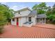 Home exterior featuring a wooden deck, a screened porch, and a bright red door at 5601 Buffaloe Rd, Raleigh, NC 27616