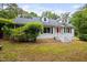 Quaint home boasting a screened in porch, lush shrubbery and dormer windows at 5601 Buffaloe Rd, Raleigh, NC 27616