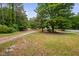 Spacious front yard with mature trees, offering a serene and inviting outdoor space at 5601 Buffaloe Rd, Raleigh, NC 27616