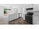 Bright kitchen features white cabinetry, modern appliances, and a sliding door to the backyard at 5601 Buffaloe Rd, Raleigh, NC 27616