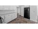 This kitchen includes a black refrigerator and lots of white cabinet space at 5601 Buffaloe Rd, Raleigh, NC 27616