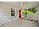 Covered porch with white lattice and a bright red door, inviting and charming at 5601 Buffaloe Rd, Raleigh, NC 27616