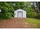 Functional storage shed with roll-up door, providing ample space for tools and equipment at 5601 Buffaloe Rd, Raleigh, NC 27616