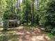 View of a small storage building in the wooded backyard at 5809 Kimbal St, Raleigh, NC 27606