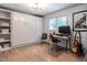 Relaxing bedroom featuring built-in closets, a workstation, a guitar, and a view to the outside at 5809 Kimbal St, Raleigh, NC 27606