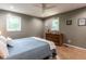 Bedroom with a hardwood floor, two windows that provide natural lighting, and a dresser at 5809 Kimbal St, Raleigh, NC 27606