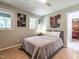 Bedroom features a queen-sized bed, hardwood floors, two windows, and decor such as band posters at 5809 Kimbal St, Raleigh, NC 27606