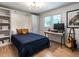 This bedroom features hardwood floors, a built-in murphy bed, shelving, and a desk next to a window at 5809 Kimbal St, Raleigh, NC 27606
