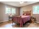 Bedroom features a full-sized bed, hardwood floors, natural lighting, and a view to the outside at 5809 Kimbal St, Raleigh, NC 27606