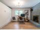 Multi-use bedroom with a gray brick fireplace, a workstation, closet and a light fixture at 5809 Kimbal St, Raleigh, NC 27606
