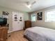 Bedroom with hardwood floors, a ceiling fan, natural lighting, a dresser, and a queen-sized bed at 5809 Kimbal St, Raleigh, NC 27606