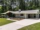 Side view showing the home's brick facade, modern carport, and spacious driveway at 5809 Kimbal St, Raleigh, NC 27606